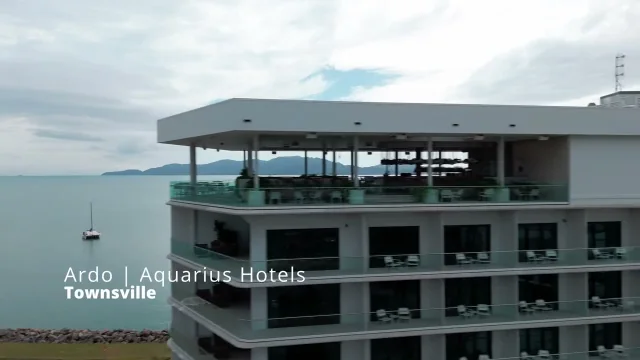 Aerial view of a hotel rooftop terrace above the bay